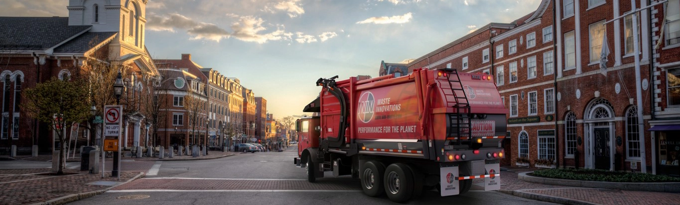 WIN truck driving in downtown Portsmouth, NH. Based out of WIN's Eliot, ME location, providing the local community with reliable and sustainable waste and recycling services.